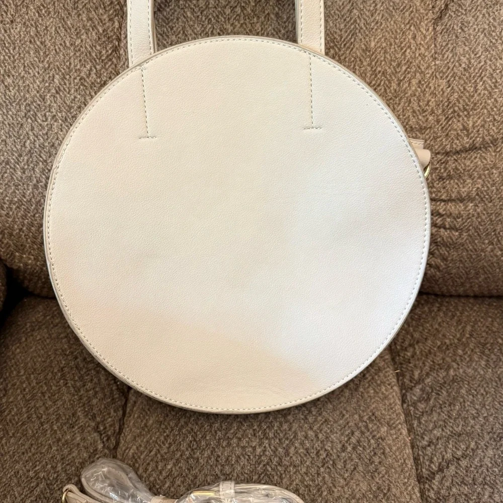 NWT Elegant Shira Leah Gray round leather handbag with a minimalist design.